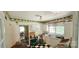 Dated kitchen with white cabinetry, black and white tile flooring, and decorative wallpaper border at 600 College Ave, Rock Hill, SC 29730