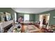 Spacious living room with hardwood floors, fireplace, and green walls at 600 College Ave, Rock Hill, SC 29730