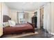 Cozy bedroom with a dark wooden bed frame, neutral walls, and natural light from the window at 6103 Warrior Ave, Fort Mill, SC 29707