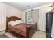 Inviting bedroom with a wooden bed frame, neutral walls, and ample natural light streaming through the window at 6103 Warrior Ave, Fort Mill, SC 29707