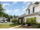 Attractive townhome with an American flag, lush landscaping, and a welcoming walkway at 6103 Warrior Ave, Fort Mill, SC 29707