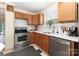 Well-lit kitchen with classic cabinetry, stainless steel appliances, and a mosaic backsplash at 6103 Warrior Ave, Fort Mill, SC 29707