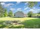 A spacious backyard featuring lush green grass and mature trees at 613 Gold Hill Dr, Salisbury, NC 28146