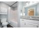 Well-lit bathroom with a shower-tub combo, granite countertop, and wooden-style floors at 613 Gold Hill Dr, Salisbury, NC 28146