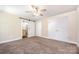 Comfortable bedroom featuring a ceiling fan, double closets, and sliding barn door to ensuite bathroom at 613 Gold Hill Dr, Salisbury, NC 28146