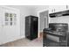 Classic kitchen featuring a black oven and refrigerator, with a view towards another room at 626 1St Se Ave, Hickory, NC 28602