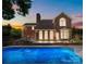 Inviting backyard with a refreshing pool, brick home, and outdoor space, perfect for relaxation and entertainment at 7213 Baniff Cir, Charlotte, NC 28277