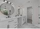 Bathroom with dual sinks, a vanity, modern fixtures, and a tile floor at 7213 Baniff Cir, Charlotte, NC 28277