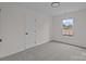 Neutral bedroom with gray carpeting, a window and a door at 7213 Baniff Cir, Charlotte, NC 28277