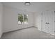 Neutral bedroom with a window, gray carpeting, and a double door closet at 7213 Baniff Cir, Charlotte, NC 28277