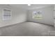 Bedroom with two windows and neutral carpeting at 7213 Baniff Cir, Charlotte, NC 28277
