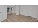 Open foyer area with wood flooring, a staircase, and neutral color palette creating a welcoming and bright entrance at 7213 Baniff Cir, Charlotte, NC 28277
