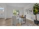 Bright home office featuring a modern desk, neutral decor, stylish artwork, a large plant, and lots of natural light at 7213 Baniff Cir, Charlotte, NC 28277