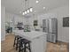 Beautiful kitchen featuring stainless steel appliances, a large island with seating, and sleek, white cabinetry at 7213 Baniff Cir, Charlotte, NC 28277