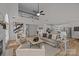 Open-concept living area showcasing a two-story ceiling, hardwood floors, and an adjacent kitchen with white cabinets at 7213 Baniff Cir, Charlotte, NC 28277
