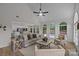 Bright living room with high ceilings, a ceiling fan, large arched windows overlooking the pool, and an open floor plan at 7213 Baniff Cir, Charlotte, NC 28277