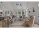 Bright living room with vaulted ceiling, fireplace, and large arched windows offering beautiful outdoor views at 7213 Baniff Cir, Charlotte, NC 28277