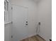 Mud room featuring a door, utility connections, and hardwood-style flooring at 7213 Baniff Cir, Charlotte, NC 28277