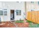 Backyard features wooden fence and patio entrance to home at 7526 Holly Grove Ct, Charlotte, NC 28227