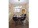 Chic dining area featuring a round table, modern chandelier, and a decorative mirror at 7526 Holly Grove Ct, Charlotte, NC 28227