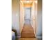 Hallway with wood floors, white doors, and neutral wall colors; creating a clean, classic look at 7526 Holly Grove Ct, Charlotte, NC 28227