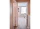 Hallway with neutral carpet leading to a bedroom, featuring two open, white doors at 7526 Holly Grove Ct, Charlotte, NC 28227