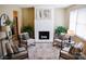 Bright living room featuring a white brick fireplace, stylish furniture, and neutral color scheme at 7526 Holly Grove Ct, Charlotte, NC 28227