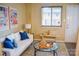 Bright living room with white sofa, art prints, a glass coffee table, and cozy bench seating at 7526 Holly Grove Ct, Charlotte, NC 28227