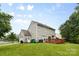 Rear exterior view showing the wooden deck, garage, and nicely maintained lawn at 9637 Brookmere Ln, Charlotte, NC 28214