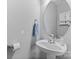 Compact half bath with pedestal sink, oval mirror, and neutral paint, offering convenience at 9637 Brookmere Ln, Charlotte, NC 28214