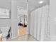 Bathroom view through the doorway to a spacious bedroom with a four-poster bed at 9637 Brookmere Ln, Charlotte, NC 28214