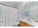 Bright bathroom featuring a white shower curtain, toilet, vanity, and mirror at 9637 Brookmere Ln, Charlotte, NC 28214
