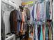 Walk-in closet with organized shelving and hanging racks filled with a variety of clothes at 9637 Brookmere Ln, Charlotte, NC 28214
