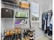 Organized closet with shelves, hanging clothes, shoes, bags, and a window for natural light at 9637 Brookmere Ln, Charlotte, NC 28214