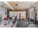 Spacious garage set up as a home gym with various exercise equipment and ample natural light at 9637 Brookmere Ln, Charlotte, NC 28214