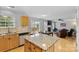 Open kitchen flows into the living room and features a center island and stainless appliances at 9637 Brookmere Ln, Charlotte, NC 28214