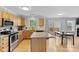 Bright, open kitchen has stainless appliances, center island, and sliding glass doors to the deck at 9637 Brookmere Ln, Charlotte, NC 28214