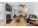 Cozy living room with a fireplace, hardwood floors, and comfortable seating at 9637 Brookmere Ln, Charlotte, NC 28214