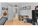 Office space with a small desk and chair, hardwood floors, and decorative wall art at 9637 Brookmere Ln, Charlotte, NC 28214