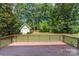 Backyard deck area perfect for entertaining or relaxing outside, complete with lush green grass and mature trees at 1002 Hollyhedge Ln, Indian Trail, NC 28079