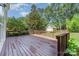 Backyard deck area perfect for entertaining or relaxing outside, complete with lush green grass and mature trees at 1002 Hollyhedge Ln, Indian Trail, NC 28079