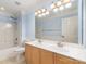 Bright bathroom with double sinks, a tub and shower, and a large mirror at 1002 Hollyhedge Ln, Indian Trail, NC 28079