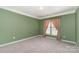Bright bedroom featuring neutral carpet and natural light from the window at 1002 Hollyhedge Ln, Indian Trail, NC 28079