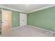 Bright bedroom featuring neutral carpet, an ensuite bath, and a double closet at 1002 Hollyhedge Ln, Indian Trail, NC 28079