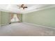 Spacious bedroom featuring neutral carpet, a ceiling fan and natural light at 1002 Hollyhedge Ln, Indian Trail, NC 28079