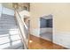 Bright foyer with hardwood floors, staircase with white railing, and access to multiple rooms at 1002 Hollyhedge Ln, Indian Trail, NC 28079