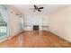 Inviting living room featuring a fireplace, hardwood floors, and built-in bookshelves at 1002 Hollyhedge Ln, Indian Trail, NC 28079