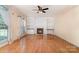 Bright and airy living room features a fireplace, hardwood floors, and built-in bookshelves at 1002 Hollyhedge Ln, Indian Trail, NC 28079