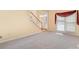 Spacious living room with staircase, large window and neutral carpet at 1002 Hollyhedge Ln, Indian Trail, NC 28079