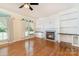 Open concept living room with a fireplace, built in bookshelves and hardwood floors at 1002 Hollyhedge Ln, Indian Trail, NC 28079